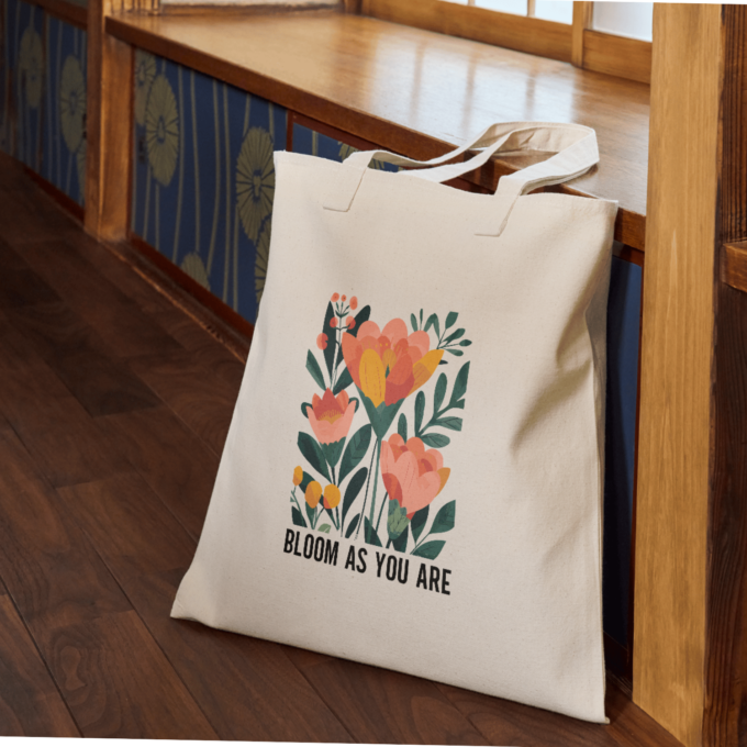 A vibrant Bloom As You Are Boho Flower Tote Bag with floral patterns on sturdy canvas fabric.