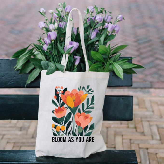 A vibrant Bloom As You Are Boho Flower Tote Bag with floral patterns on sturdy canvas fabric.