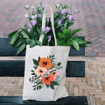 A vibrant Bloom As You Are Boho Flower Tote Bag with floral patterns on sturdy canvas fabric.