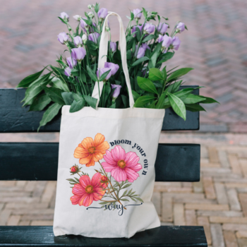 A stylish Bloom Your Own Way Boho Flower Tote Bag with vibrant floral designs on durable canvas fabric.