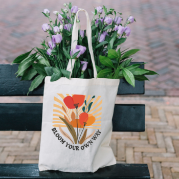 A stylish Bloom Your Own Way Boho Flower Tote Bag with vibrant floral designs on durable canvas fabric.