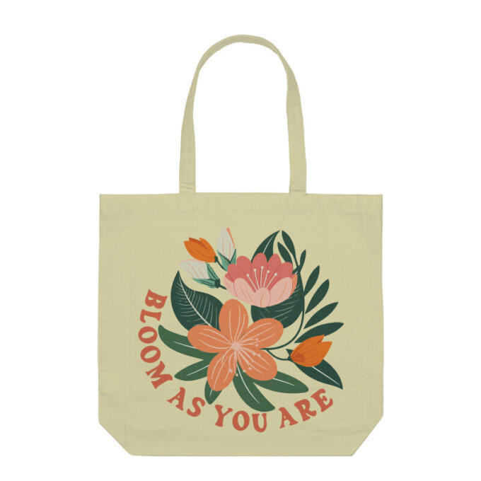 A vibrant Bloom As You Are Boho Flower Tote Bag with floral patterns on sturdy canvas fabric.