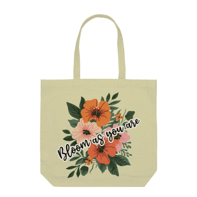 A vibrant Bloom As You Are Boho Flower Tote Bag with floral patterns on sturdy canvas fabric.