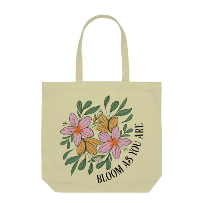 A vibrant Bloom As You Are Boho Flower Tote Bag with floral patterns on sturdy canvas fabric.